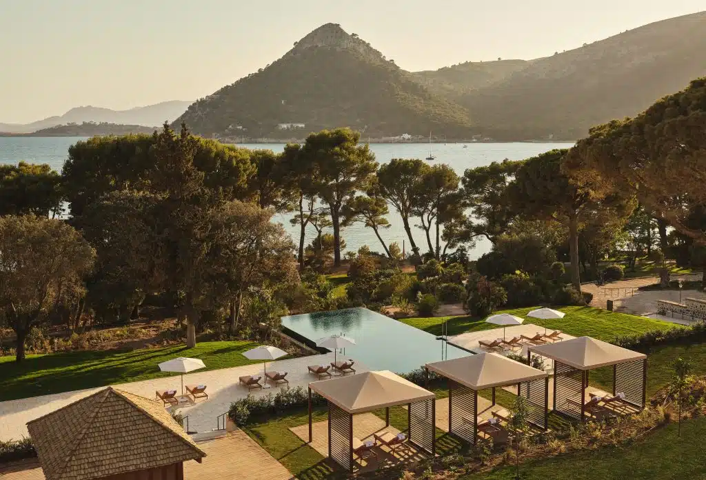The garden, infinity pool and cabanas of the Four Seasons Resort Mallorca at Formentor above the bay