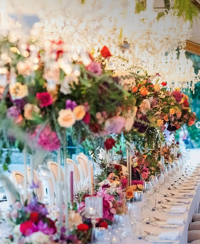 Jewel-box florals under the chandeliers